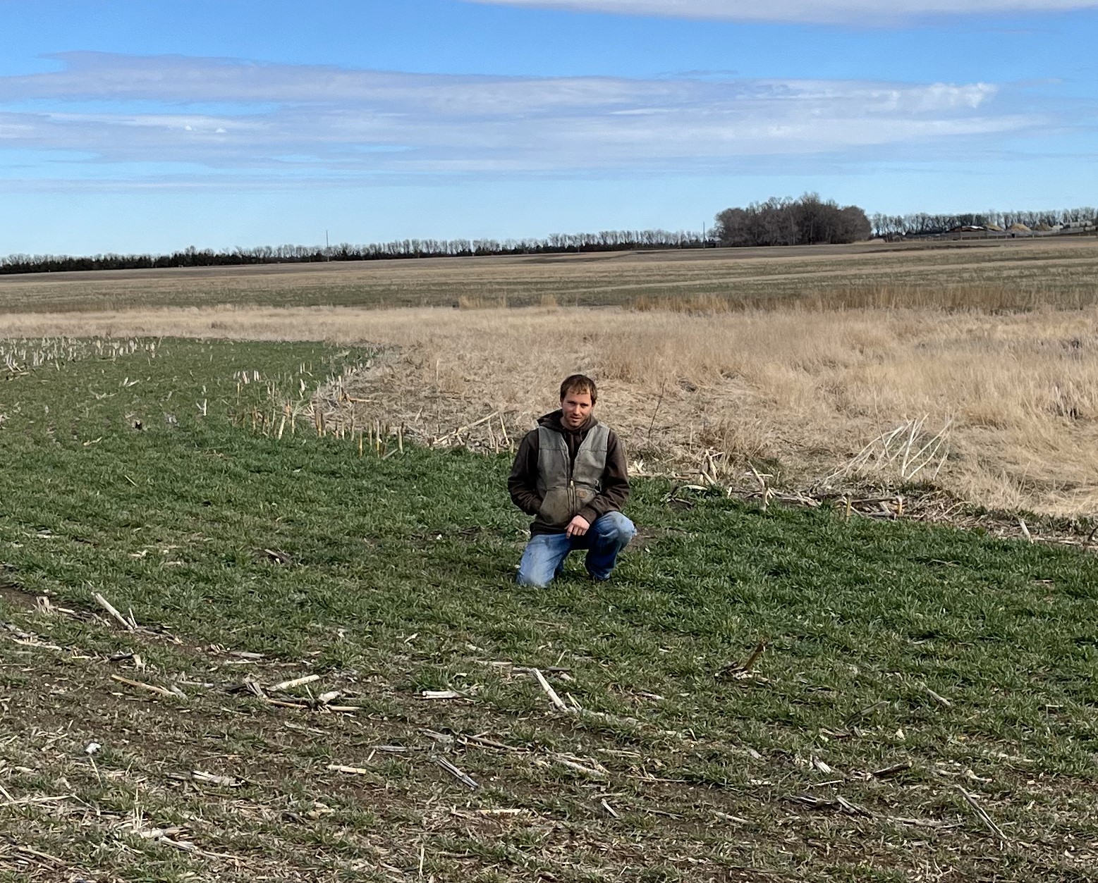 South Dakota farmer poses in a rye field - which he planted to help improve his land during the winter months.